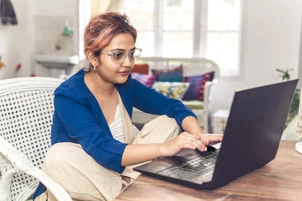 person setting up an html redirect on a laptop